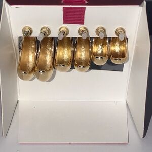 Set of three gold half hoop designer style earrings.
